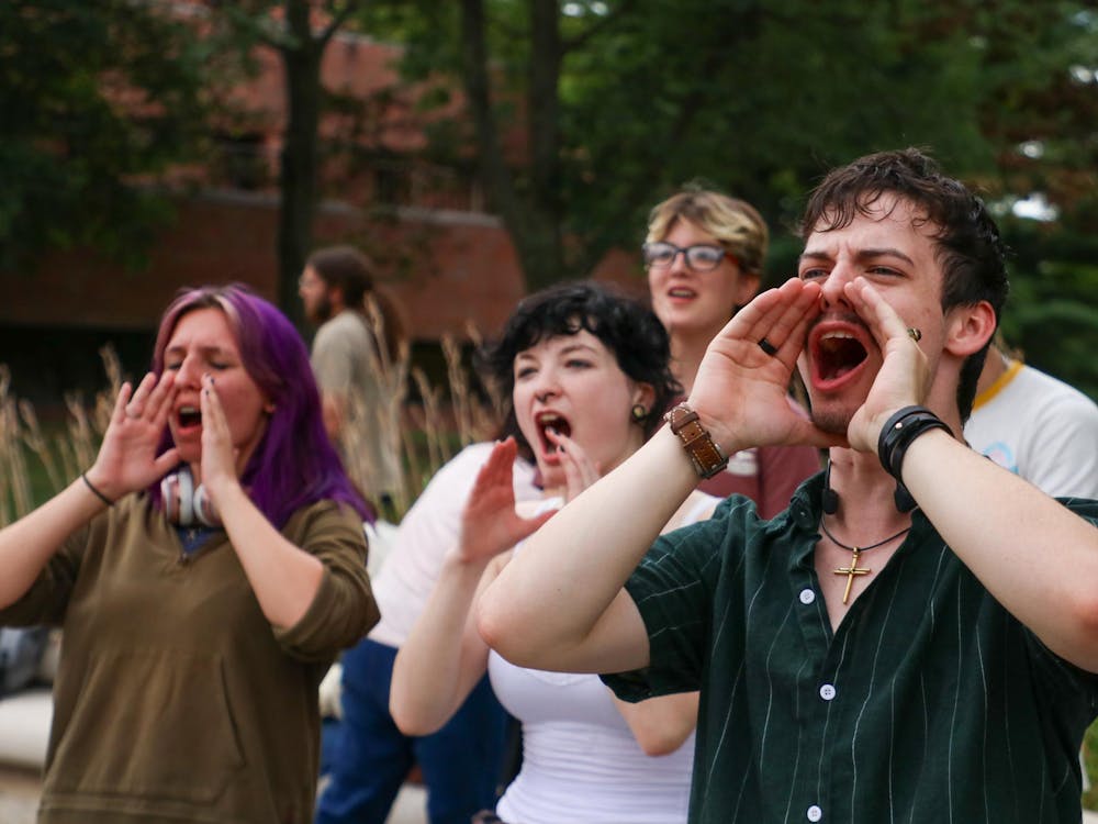 A group of students shout at a protest Aug. 22 at Ball State University. The protest was organized to speak out against police brutality. Adam Jones, DN