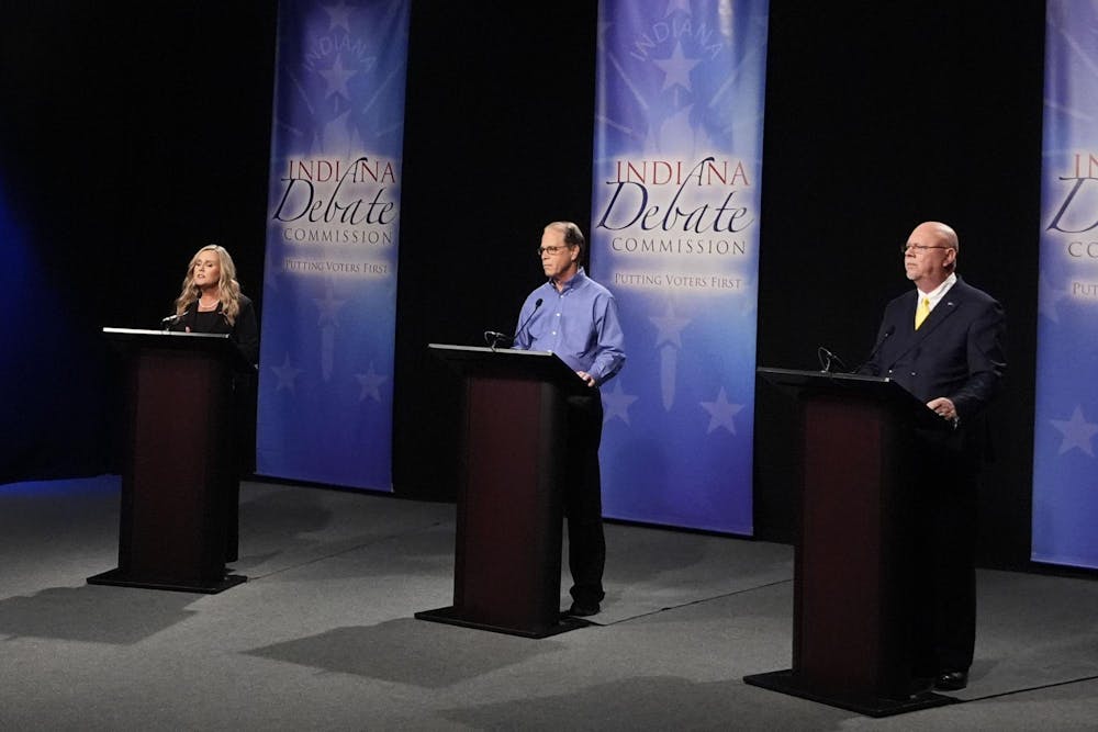 Democrat candidate Jennifer McCormick, left, speaks as Republican candidate Sen. Mike Braun, R-Ind., middle, and Libertarian candidate Donald Rainwater listen during a debate for Indiana governor hosted by the Indiana Debate Commission at WFYI, Thursday, Oct. 24, 2024, in Indianapolis. (AP Photo/Darron Cummings, Pool) 