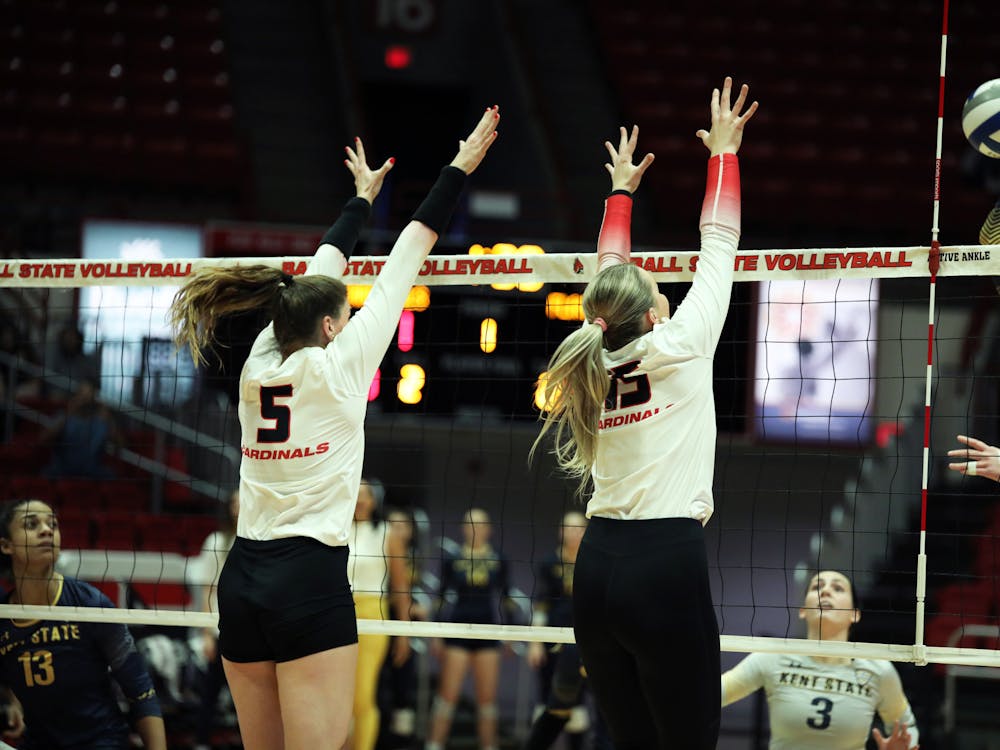 Graduate Student middle blocker Marie Plitt (left) and Junior setter Megan Wielonski (right) blocks the ball against Kent State Oct. 27 at Worthen Arena. The Cardinals won 3-0 against the Flashes. Mya Cataline, DN