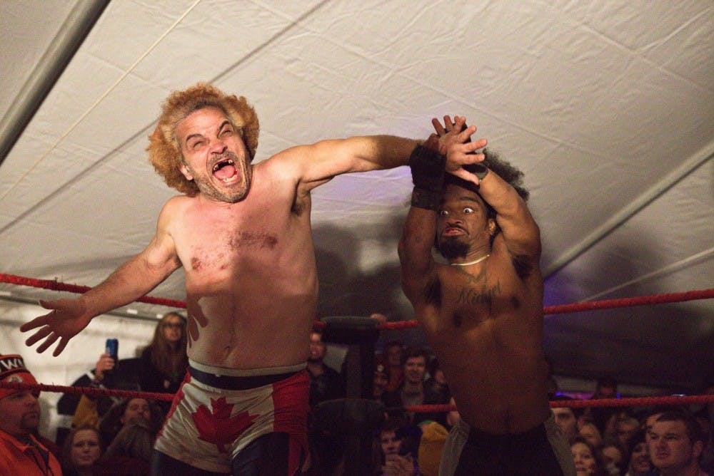 <p>Jacob "Lil' Nasty" Brookes yells as Trey "King Midget" Jackson clings onto his hand. Brookes and Jackson tussled in the Extreme Midget Wrestling Federation's first match of the night. DN PHOTO LAUREN DAHLHAUSER</p>