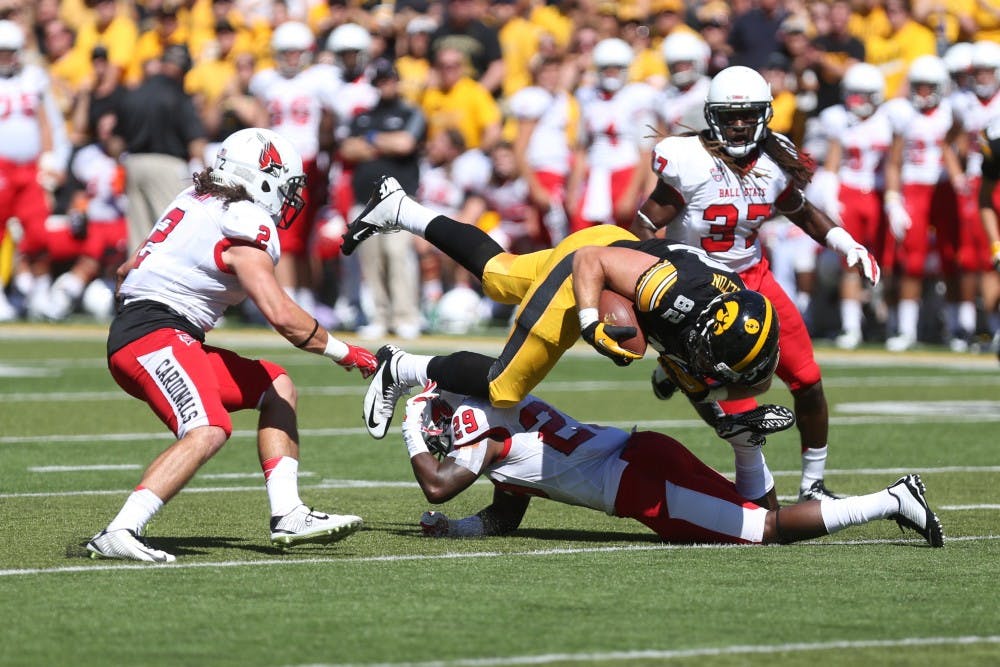 Iowa tight end Ray Hamilton gets tackled by Ball State strong safety Brian Jones on Sept. 6 in Kinnick Stadium. Iowa defeated Ball State, 17-13. (The Daily Iowan/Tessa Hursh)