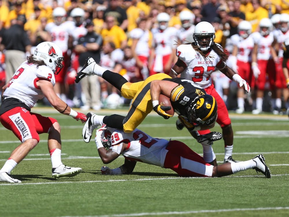 Iowa tight end Ray Hamilton gets tackled by Ball State strong safety Brian Jones on Sept. 6 in Kinnick Stadium. Iowa defeated Ball State, 17-13. (The Daily Iowan/Tessa Hursh)
