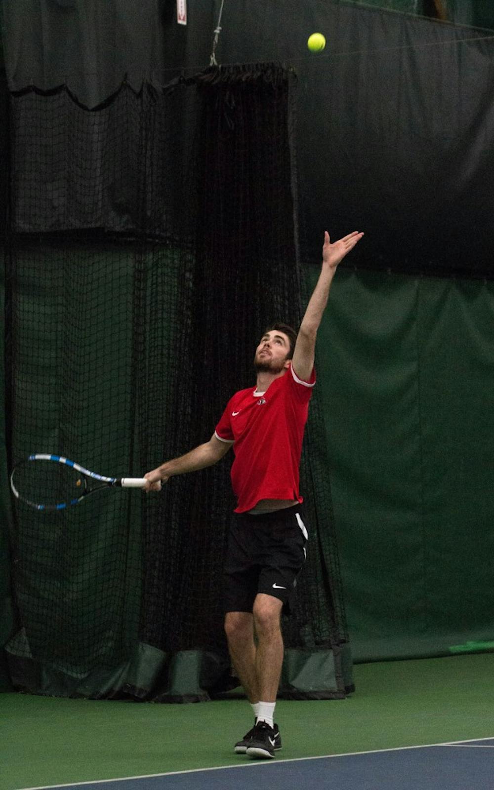 Sophomore Tom Carney prepares to serve the ball during his doubles match with teammate Matt Helm against Eastern Illinois' Jared Woodson and Freddie Ammer on Jan. 22 at Muncie's Northwest YMCA. The Cardinals won 6-1. Grace Ramey // DN