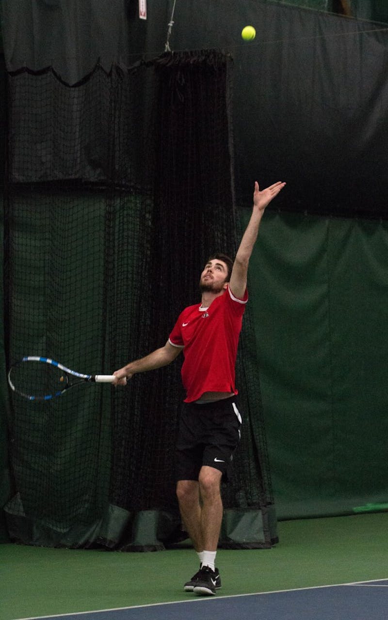 Sophomore Tom Carney prepares to serve the ball during his doubles match with teammate Matt Helm against Eastern Illinois' Jared Woodson and Freddie Ammer on Jan. 22 at Muncie's Northwest YMCA. The Cardinals won 6-1. Grace Ramey // DN