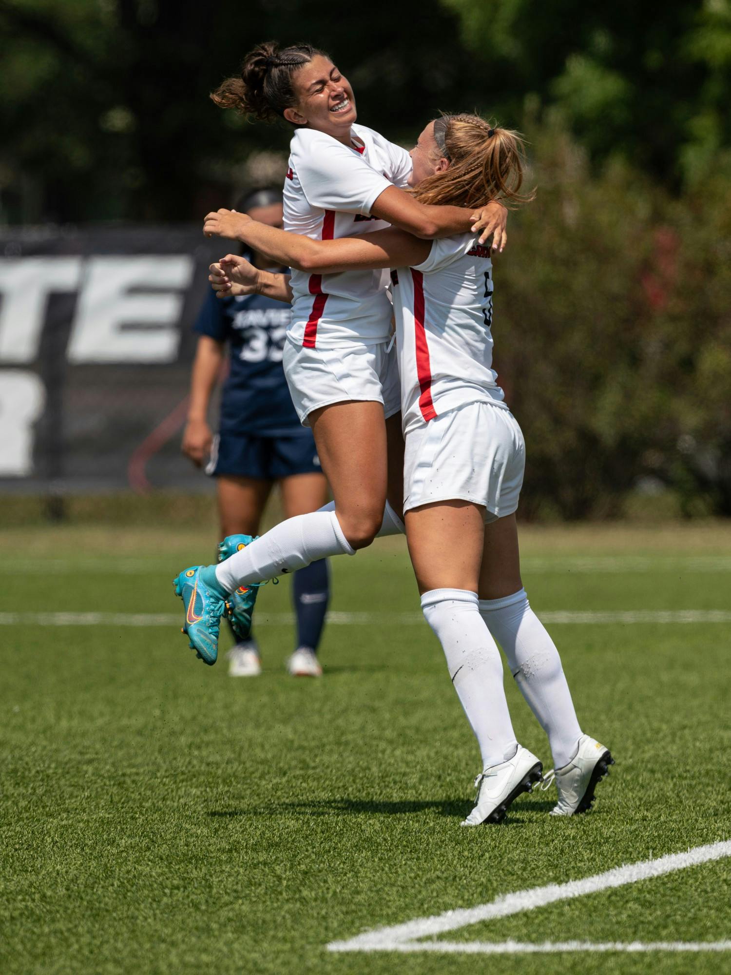 Junior defender Ryann Locante (left) jumps into the arms of teammate Avery Fenchel (right) after scoring a goal in the first of Ball State Soccer's game against Xavier Aug. 28 at the Briner Spoerts Complex. The Cardinals lost the match 4-2 to Xaiver. Eli Houser, DN