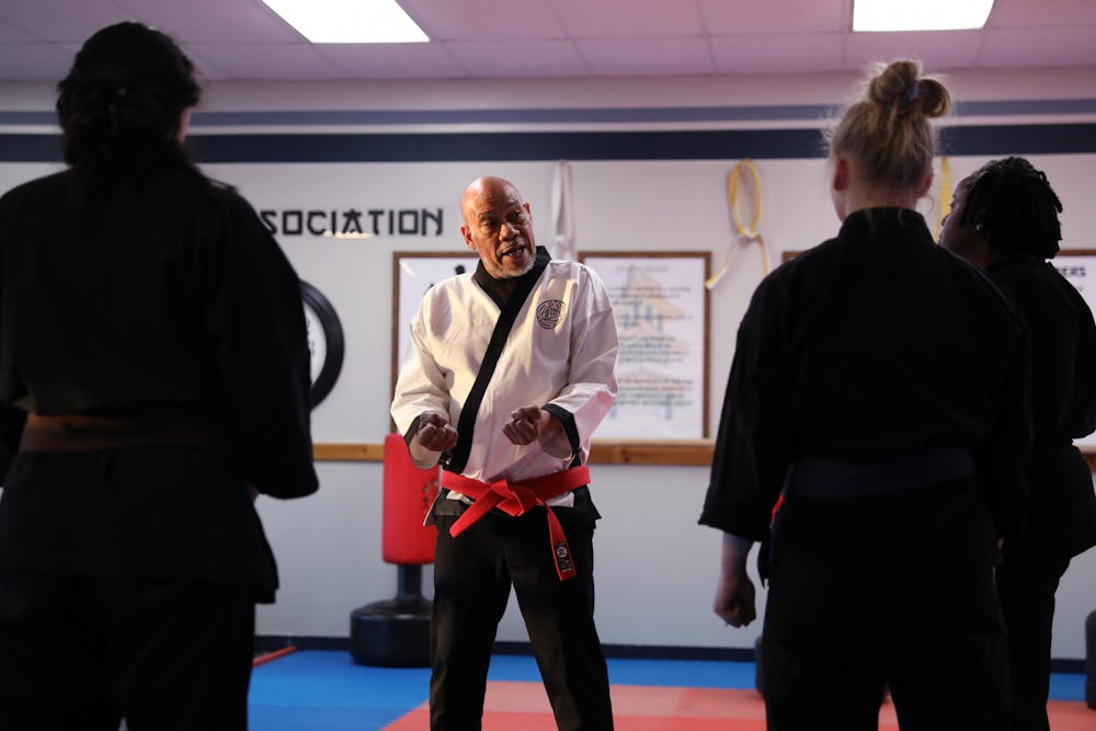 Grand Master Ron White (center) talks to a class about self defense at the White & Rymer Bushido Dojo March 14 in Muncie, Ind. Amber Pietz, DN