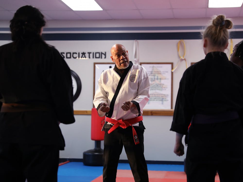 Grand Master Ron White (center) talks to a class about self defense at the White & Rymer Bushido Dojo March 14 in Muncie, Ind. Amber Pietz, DN