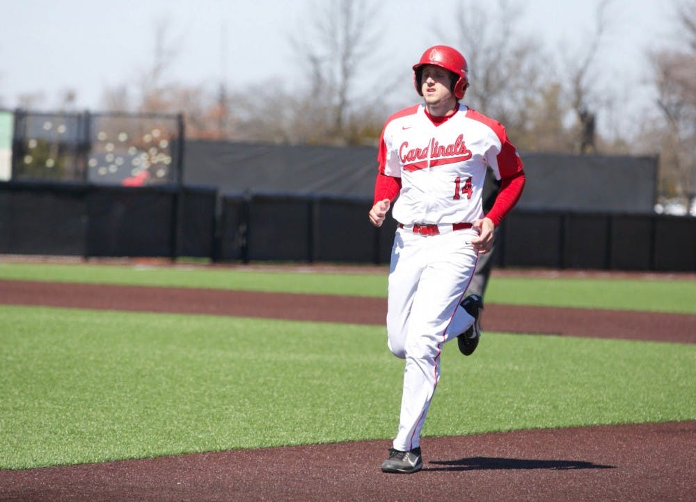 <p>Freshman Rhett Wintner runs back to first base after one of his teammates strikes out during the fourth inning of the game against Dayton March 18. <strong>Carlee Ellison, DN</strong></p>