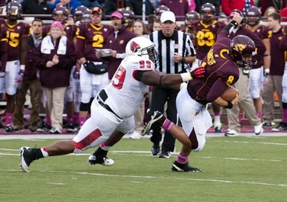 Graduate defensive lineman Brandon Newman grabs Central Michigan quarterback Ryan Radcliff for a sack Oct. 20. Newman transferred from Notre Dame to Ball State for a starting position during his last year of eligibility. DN FILE PHOTO BOBBY ELLIS