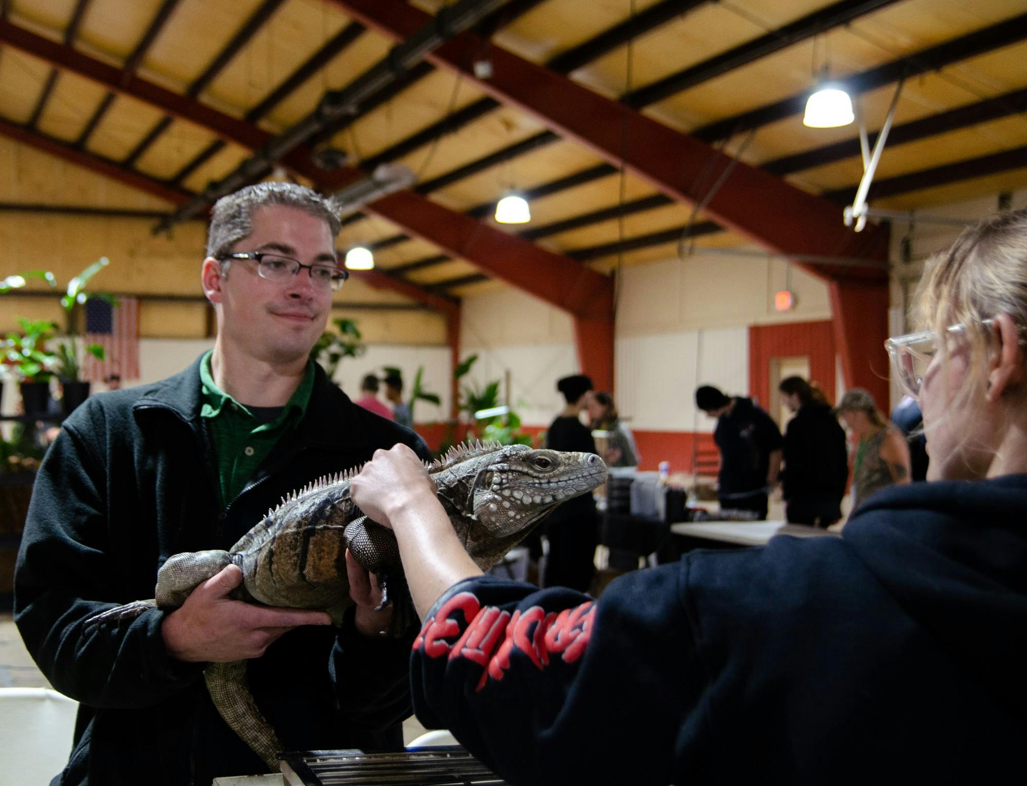 A guest pets Jason Michael's 3-year-old Cuban rock iguana on Sunday, Sept. 10. Alex Bracken, DN