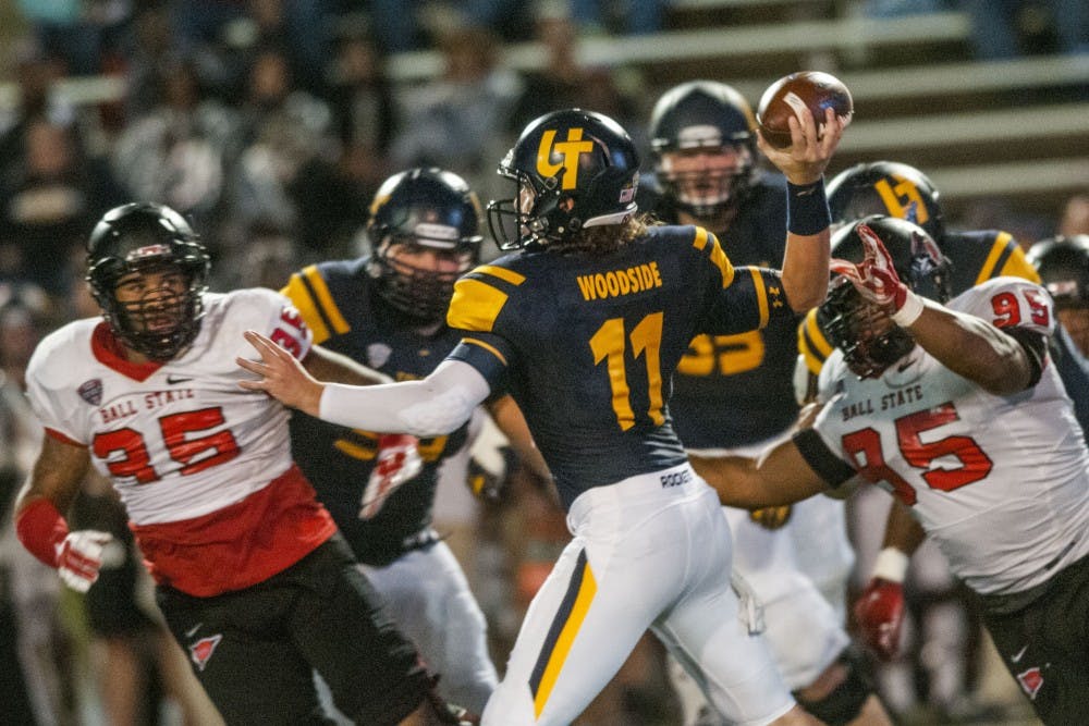 The Ball State defense pressures Toledo quarterback Logan Woodside during the game against Toledo at the Glass Bowl on Sept. 21. DN PHOTO JONATHAN MIKSANEK