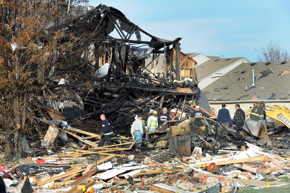 Numerous emergency scene investigators, along with members of Citizens Energy Group, survey the destroyed homes along Fieldfare Way on the Southside of Indianapolis the day following the explosion. Several homes damaged by the explosion have been slated for demolition. PHOTO COURTESY OF MATT KRYGER OF THE INDIANAPOLIS STAR