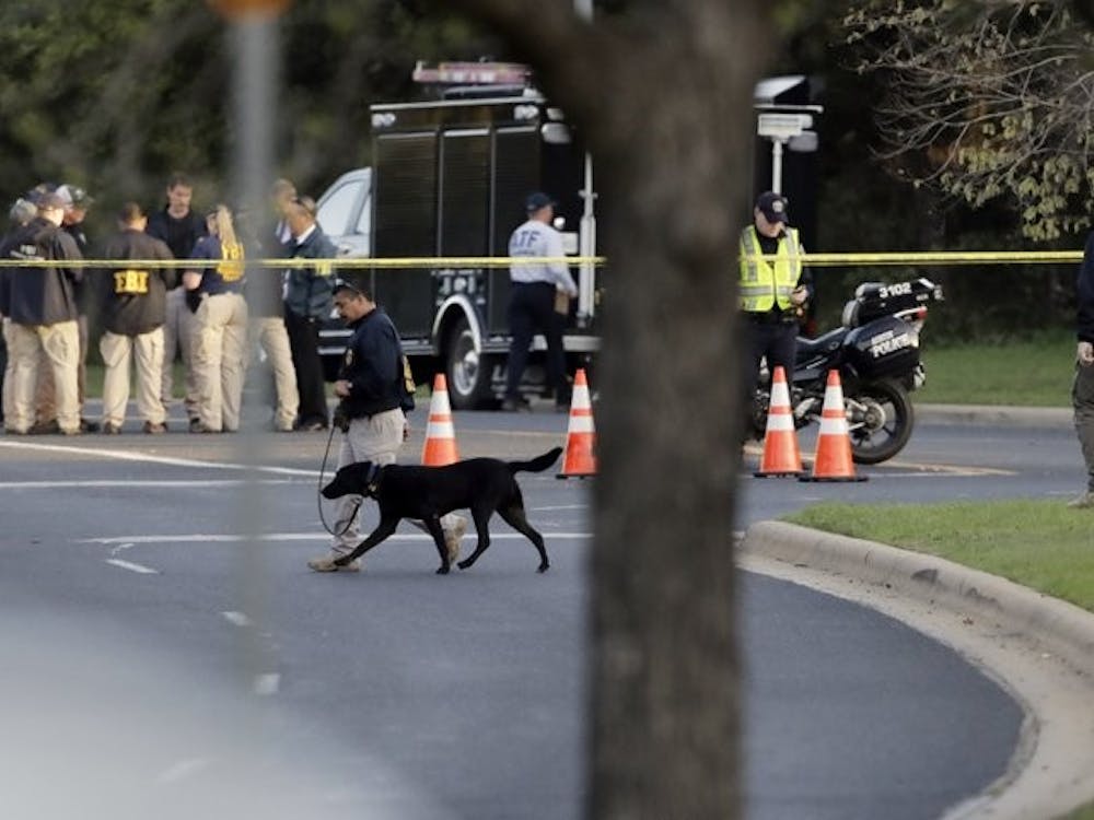 Officials work and stage near the site of Sunday's deadly explosion, Monday, March 19, 2018, in Austin, Texas. Police warned nearby residents to remain indoors overnight as investigators looked for possible links to other package bombings elsewhere in the city this month. Associated Press