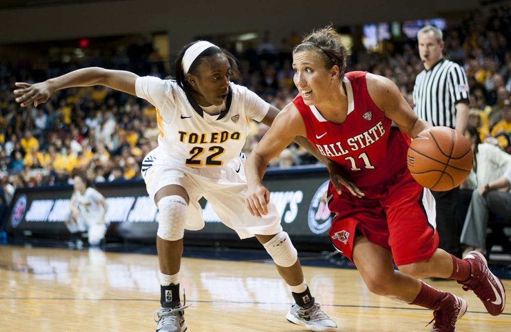 Junior guard Brandy Woody pushes past Toledo's Andola Dortch during their game March 6 at Savage Arena. Woody was fouled out in the second half for her 5 personal against Toledo. DN PHOTO JONATHAN MIKANEK