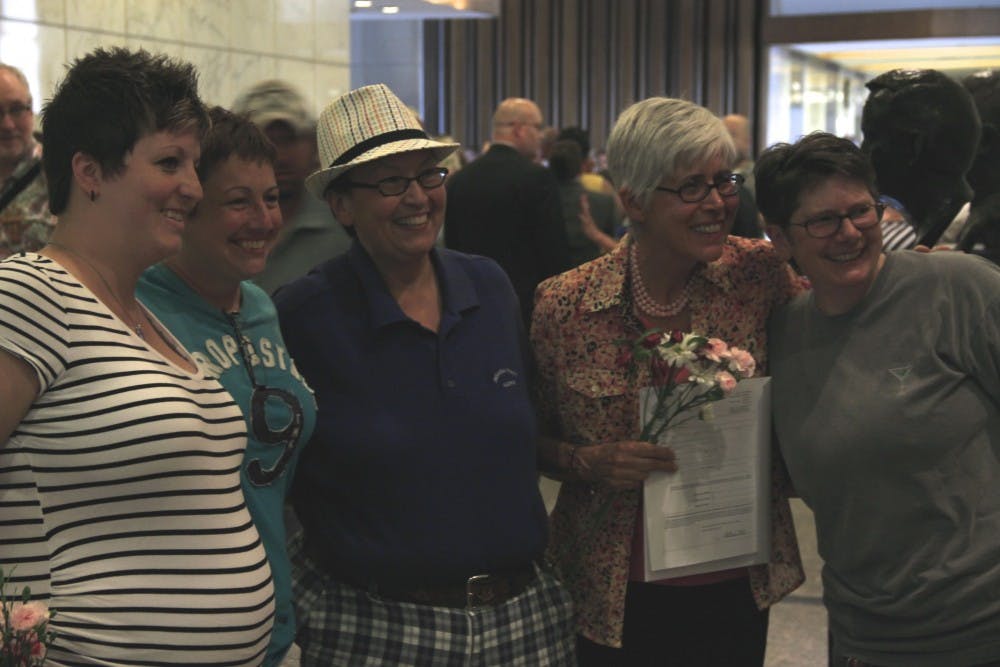 Same-sex couples pose for photos after receiving legal recognition of their marriage June 25 at the Marion County Clerk