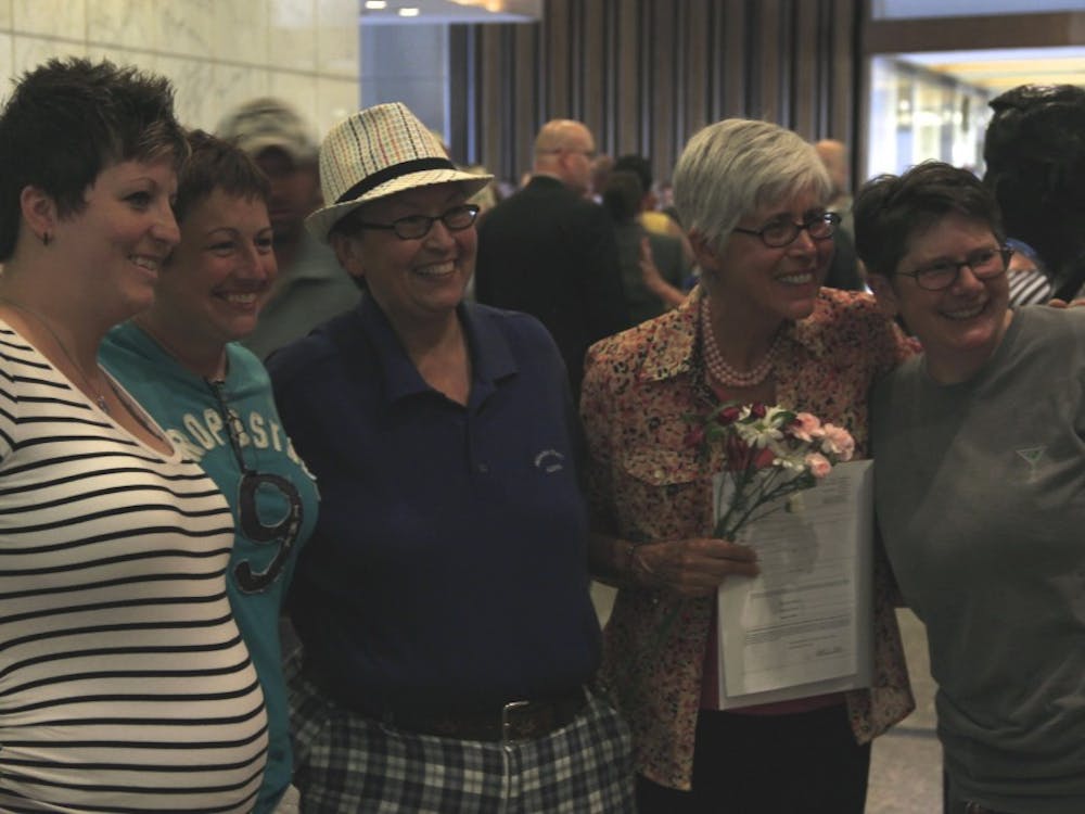 Same-sex couples pose for photos after receiving legal recognition of their marriage June 25 at the Marion County Clerk
