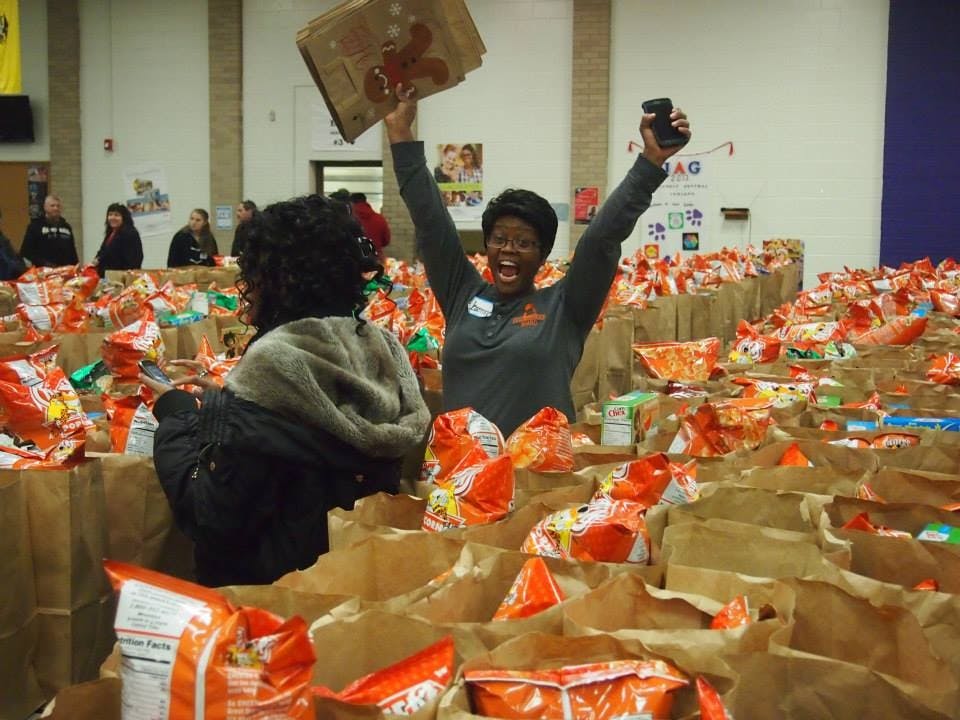 A Feed My Sheep volunteer celebrated the amount of donations the organization received at its annual food drive. Feed My Sheep volunteers will feed people within the Muncie community on Thanksgiving. Feed My Sheep Muncie, Photo Provided