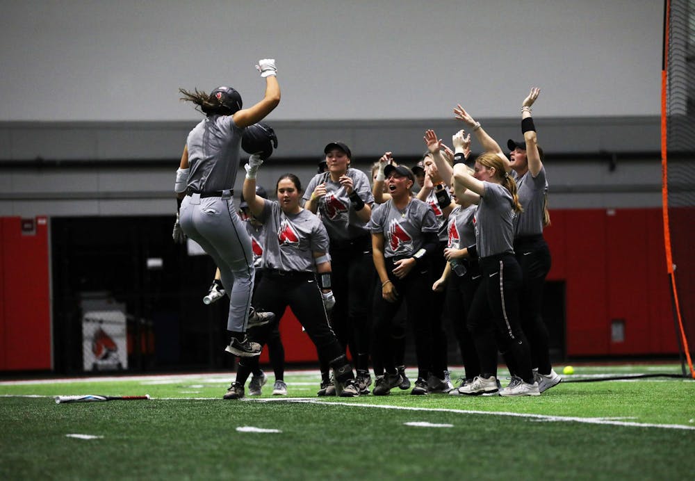 Redshirt junior utility McKayla Timmons celebrates with teammates at homebase after hitting a home run during a practice scrimmage Jan. 26 at Scheumann Family Indoor Practice Facility. Timmons has a hitting average of .342 after two seasons with Ball State. Mya Cataline, DN
