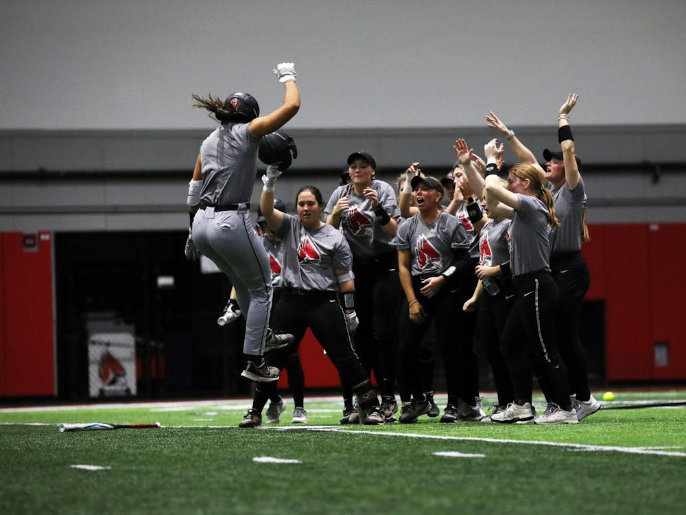 Redshirt junior utility McKayla Timmons celebrates with teammates at homebase after hitting a home run during a practice scrimmage Jan. 26 at Scheumann Family Indoor Practice Facility. Timmons has a hitting average of .342 after two seasons with Ball State. Mya Cataline, DN