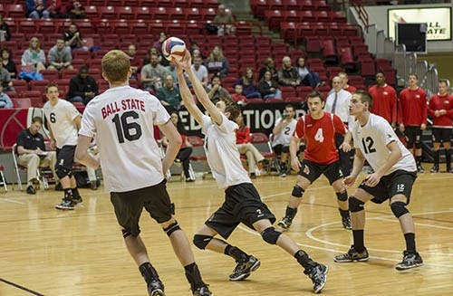 Sophomore Shane Witmer takes a set from mid court in order to set up their spike against IPFW on Feb. 13. DN PHOTO COREY OHLENKAMP