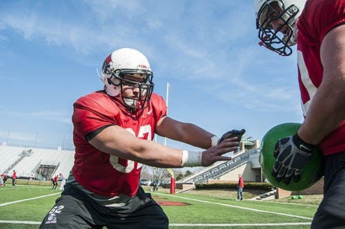 Junior Jacob Richard runs through tackling drills during spring practice on April 5. The football team will host their spring game on April 20. DN FILE PHOTO BOBBY ELLIS
