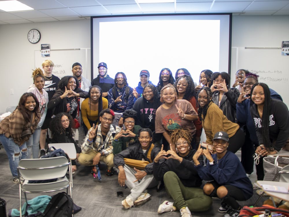 Audience members and organizers come together for a group picture in the Whitinger Business Building Nov. 9. This concluded the evening of discussion. Jayda Mann, DN