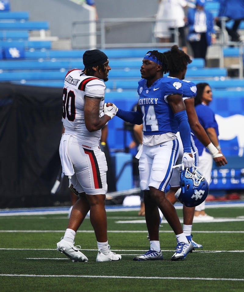 Caden Johnson speaking with Ty Bryant after Ball State's 44-14 loss to Kentucky Sept. 2 at Kroger Field. Johnson went to Fredrick Douglas High School in Lexington, Kentucky, with Bryant. Mya Cataline, DN