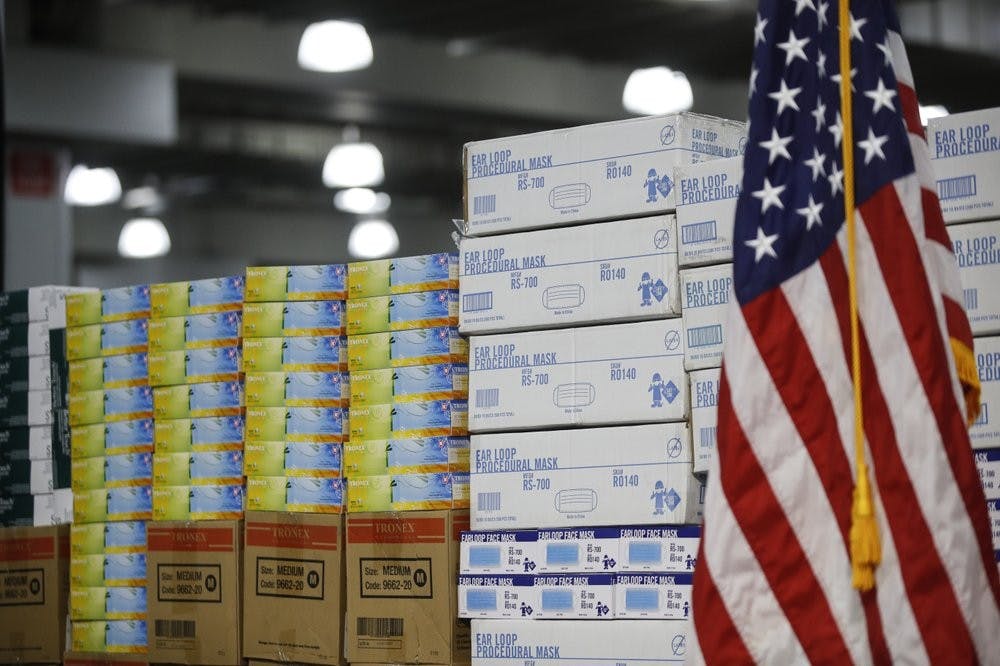 In this March 24, 2020, file photo stacks of medical supplies are housed at the Jacob Javits Center that will become a temporary hospital in response to the COVID-19 outbreak in New York. A review of federal purchasing contracts by The Associated Press shows federal agencies waited until mid-March to begin placing bulk orders of N95 respirator masks, mechanical ventilators and other equipment needed by front-line health care workers. (AP Photo/John Minchillo, File)