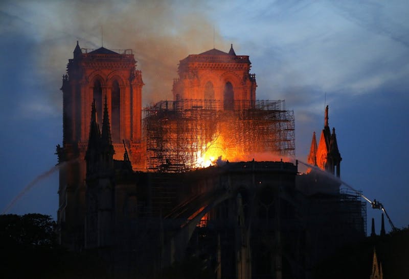 Smoke and flames rise from the Notre Dame Cathedral April 15, 2019, in Paris after a fire broke out Monday afternoon and quickly spread across the building, collapsing the spire. The cause is yet unknown but officials said it was possibly linked to ongoing renovation work.(AP Photo/Michel Euler)