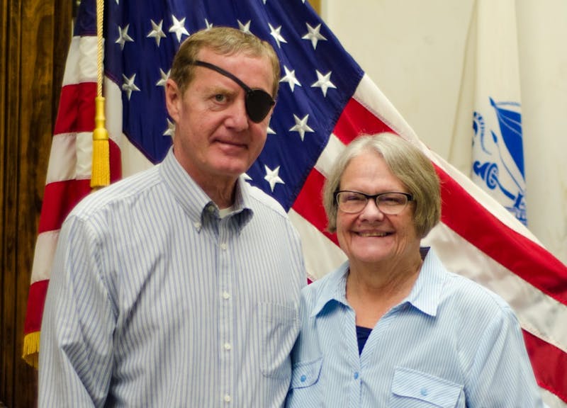 Rick and Michele Stonecipher stand together in front of the American flag Oct. 31, 2018, at the Delaware County Building, after they finished a training meeting. The Stoneciphers are paid volunteers who organize the set-up of polls at Southside Middle School. Stephanie Amador, DN