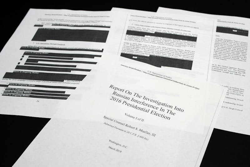 Four pages of the Mueller Report lay on a witness table in the House Intelligence Committee hearing room on Capitol Hill, in Washington, Thursday, April 18, 2019. (AP Photo/Cliff Owen)