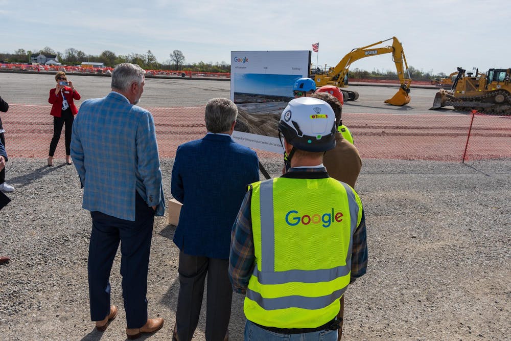 Indiana Gov. Eric Holcomb, in blue, looks at an aerial overview of Google’s data center project in Fort Wayne during an announcement and groundbreaking ceremony on April 26, 2024. (From Holcomb’s official Flickr)
