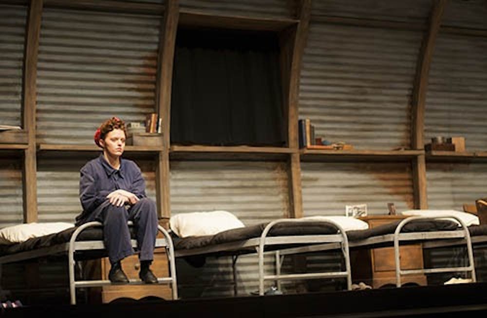 Dawn, played by Mary Kate Young, sits at the edge of her bed in contemplation of her position in life. Wrens tells the story of 7 women trying to understand themselves, their relationships to others and their value system. Wrens will open today in University Theatre. DN PHOTO JONATHAN MIKSANEK
