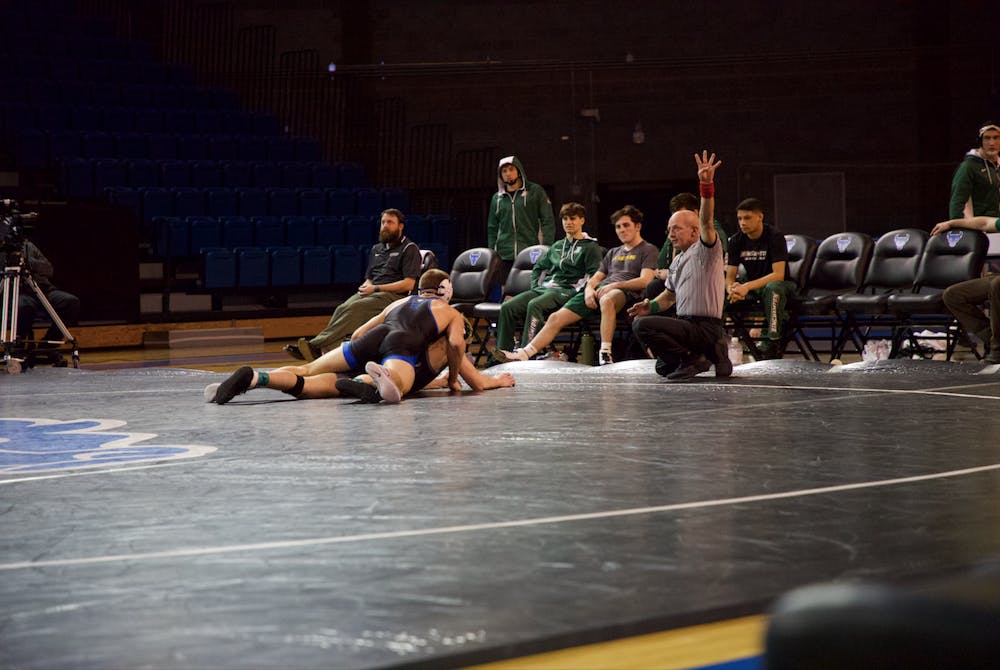 <p>UB senior wrestler Troy Keller grapples Binghamton University junior Dylan Wood in February.</p>