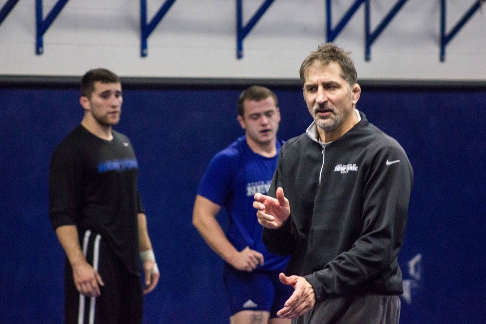 <p>Head coach John Stutzman leads a practice from before the 2015-16 season.</p>