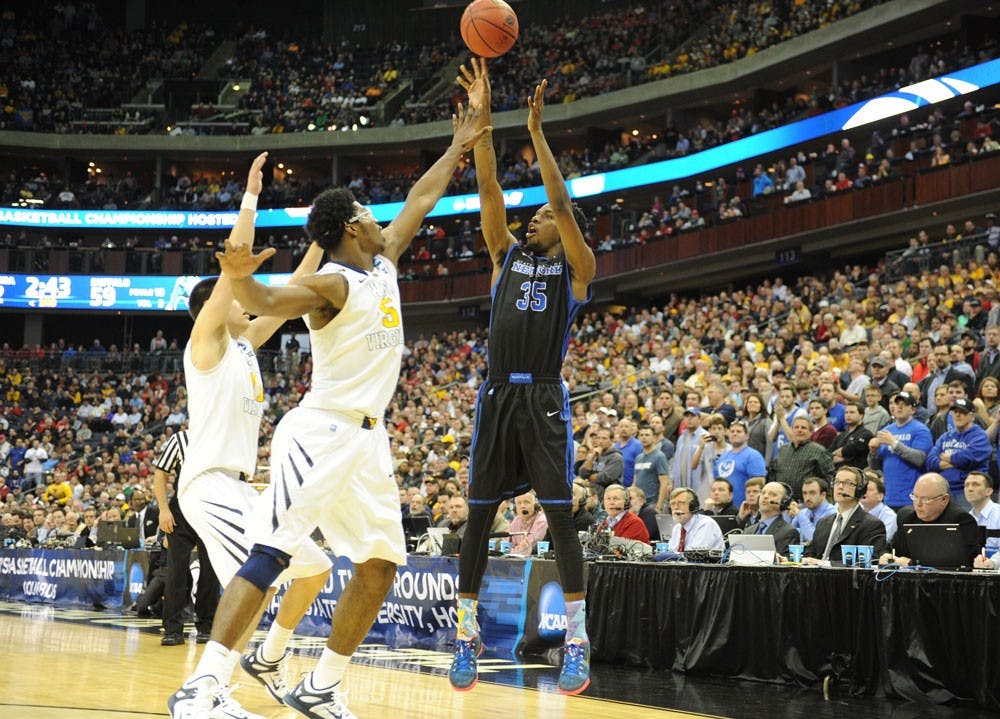 <p>Senior forward Xavier Ford attempts a corner 3-pointer over West Virginia forward Devin Williams in the second round of the program’s first NCAA tournament appearance.</p>