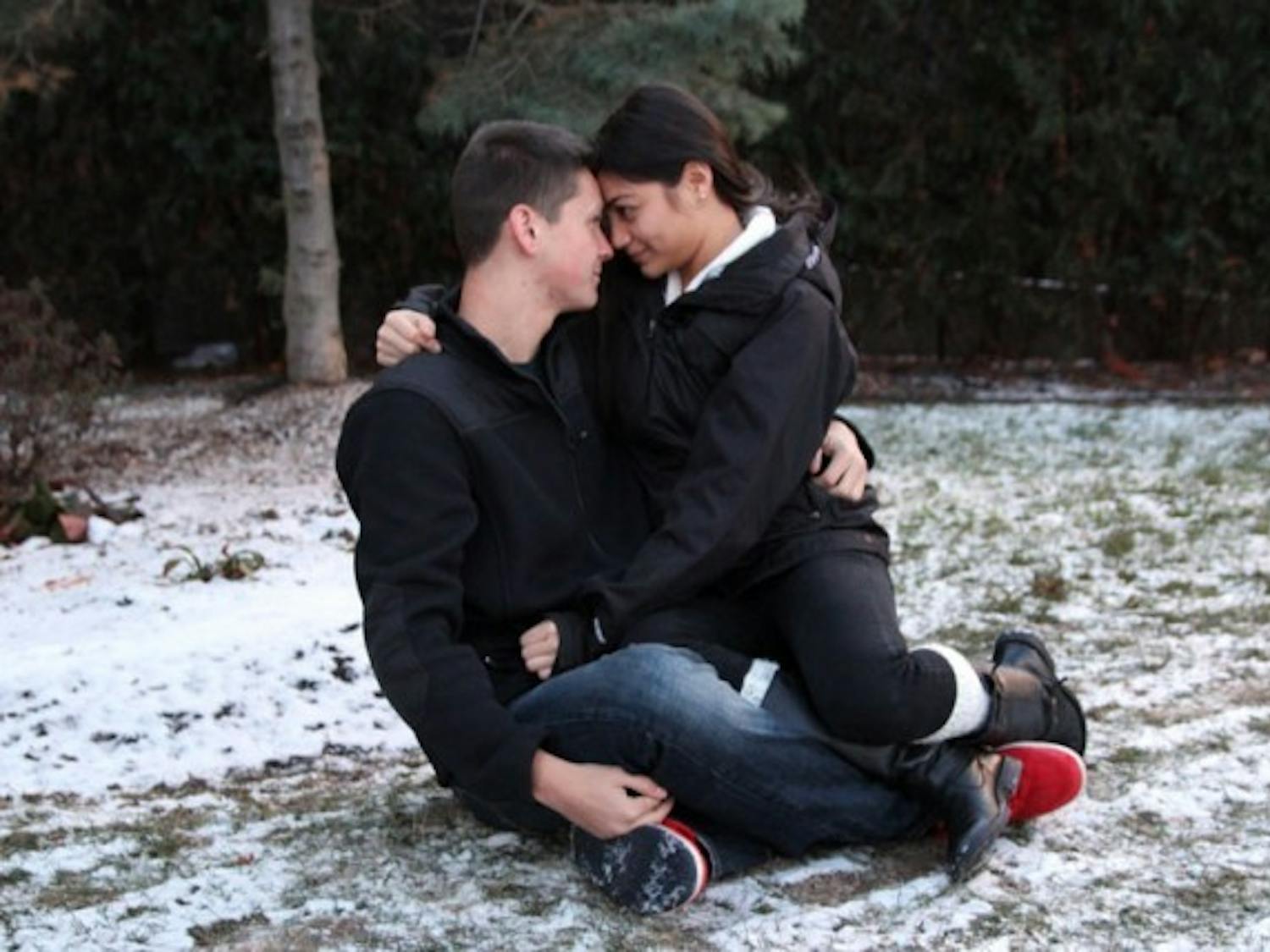 Matt Folaron, an undecided freshman, and Jocelyn Alvarado, a freshman pharmaceutical major, (above) share an intimate moment, keeping each other warm. The two have been dating for two and a half months and are embracing onset of “cuffin’ season.” Alvarado believes cuffing season is real because "people suddenly realize they can't go out and party anymore," she said. Brian Windschitl, The Spectrum
