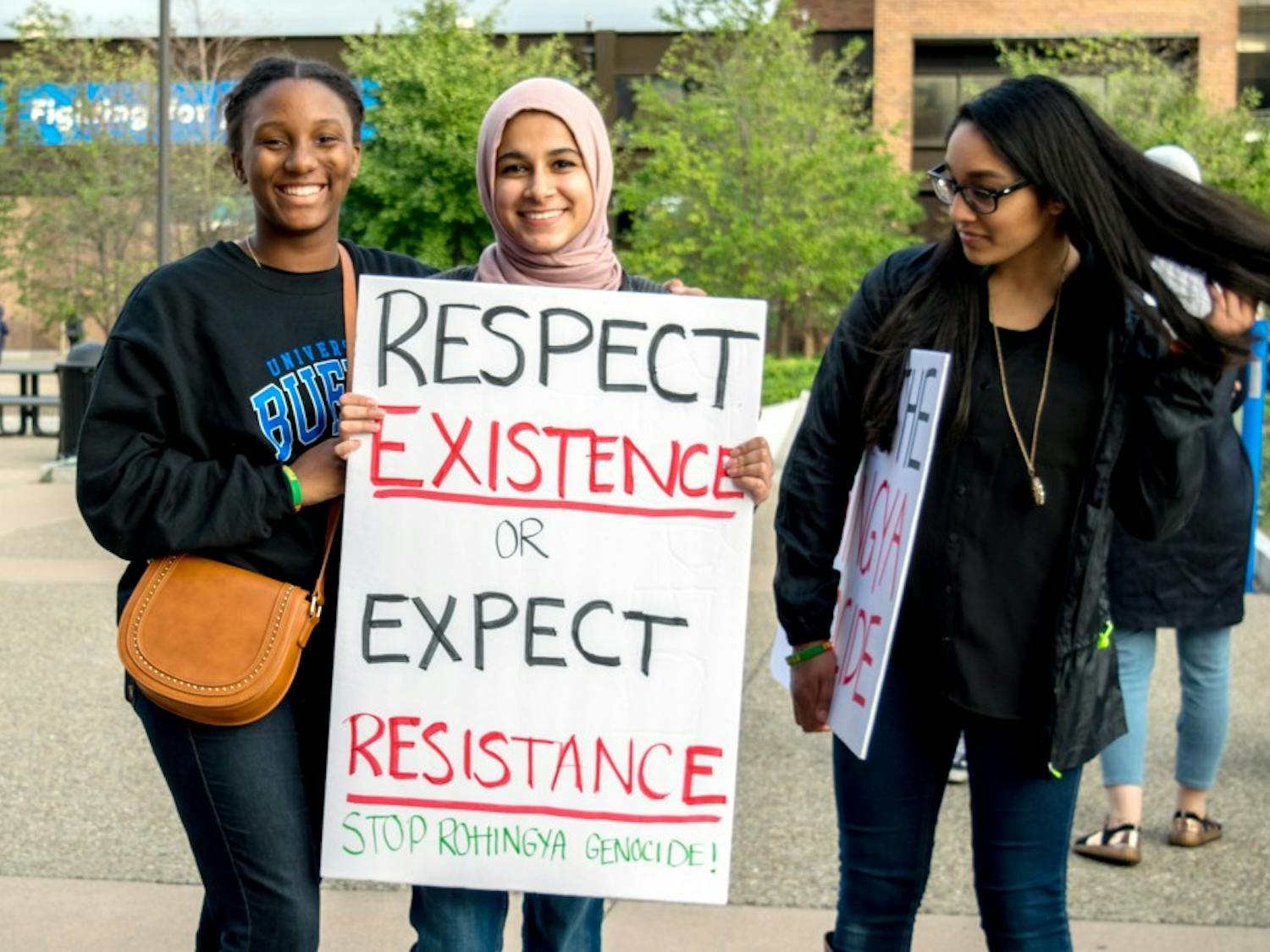 Students participating in the Muslim Student Association's&nbsp;Walk with Us event hold a&nbsp;poster supporting Rohingya refugees.