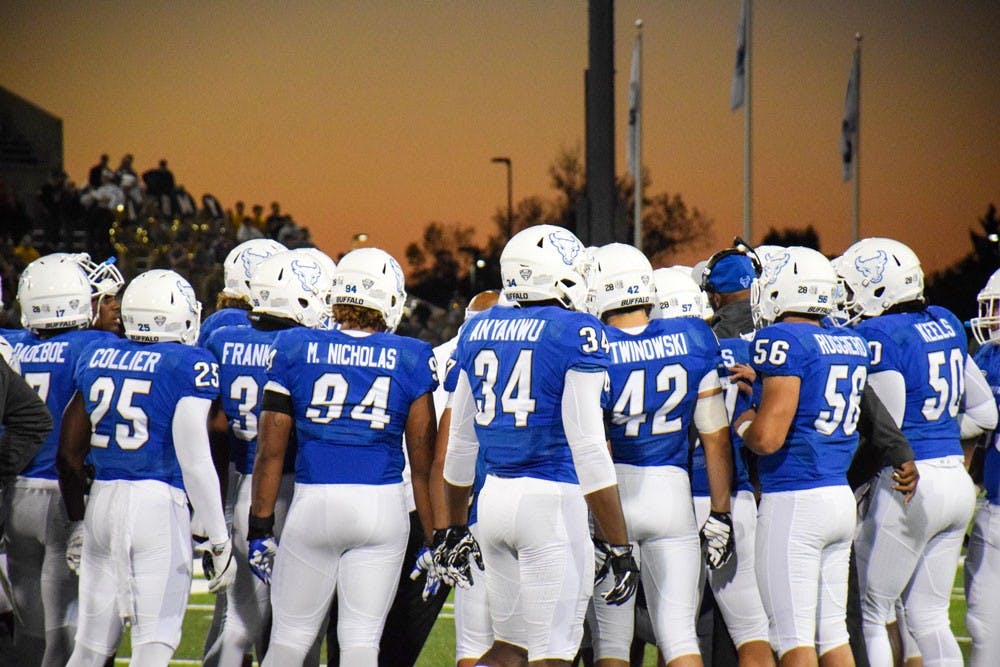 <p>UB football huddles before a&nbsp;game. The Bulls lost to Western Michigan on Saturday.&nbsp;</p>