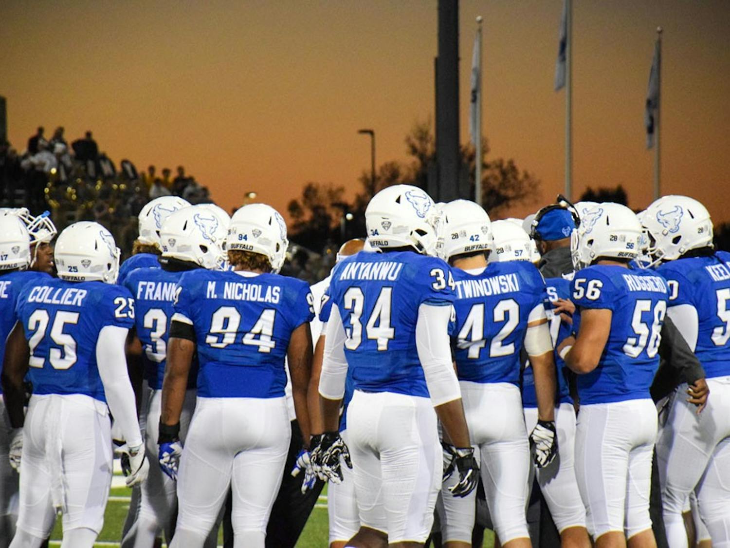 UB football huddles before a game. The Bulls lost to Western Michigan on Saturday. 