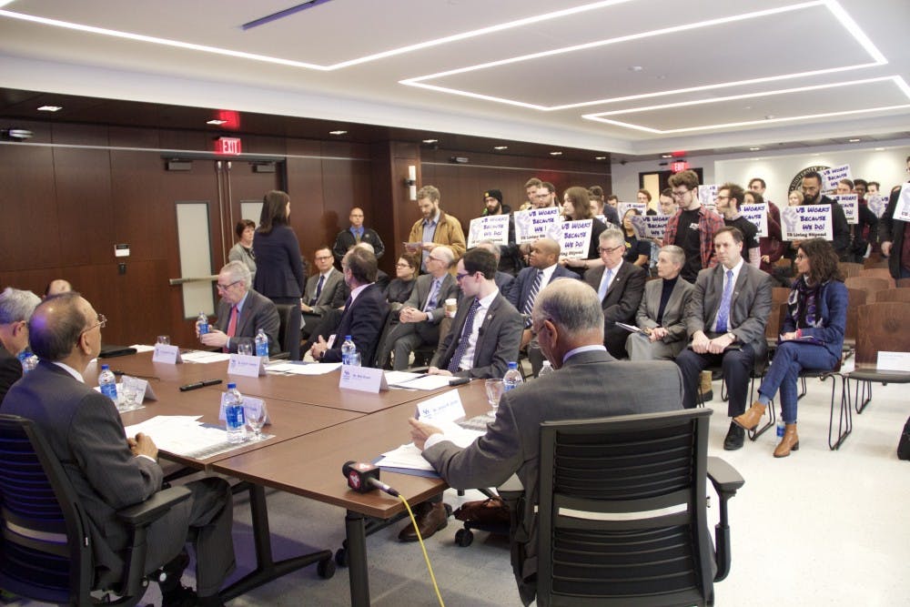 <p>Jessica Baker, SUNY associate, explains the Open Meetings Law to English Ph.D. student Willis McCumber. McCumber disrupted the UB Council meeting to advocate for graduate student stipends.</p>