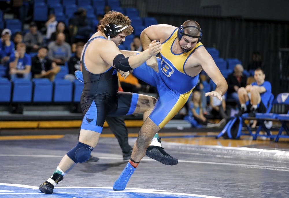 <p>Redshirt junior Jake Gunning takes down an opponent. Gunning is the reigning MAC champion in the heavyweight division.</p>