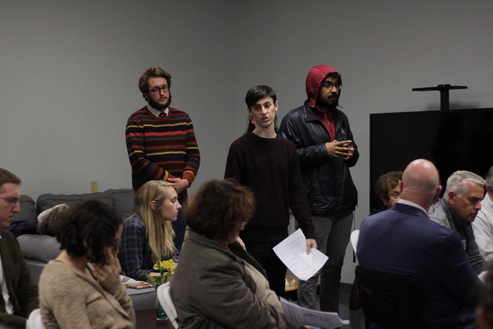 Students recite prayers from the Torah on Monday at Hillel of Buffalo. The on-campus organization held a vigil for the 11 victims of the Tree of Life synagogue massacre.&nbsp;