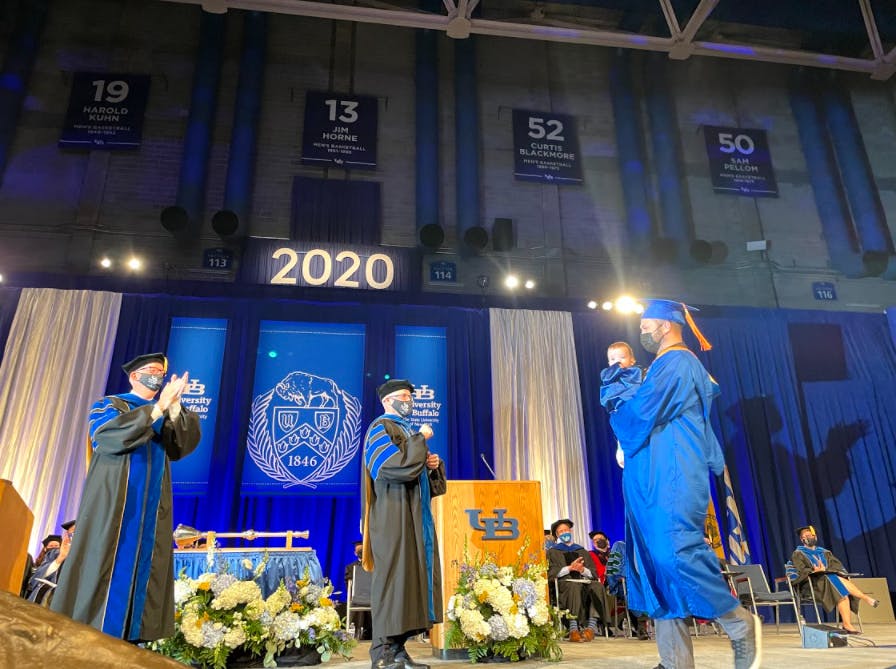 David Hooper walked the stage with his nine-month-old on Friday.
