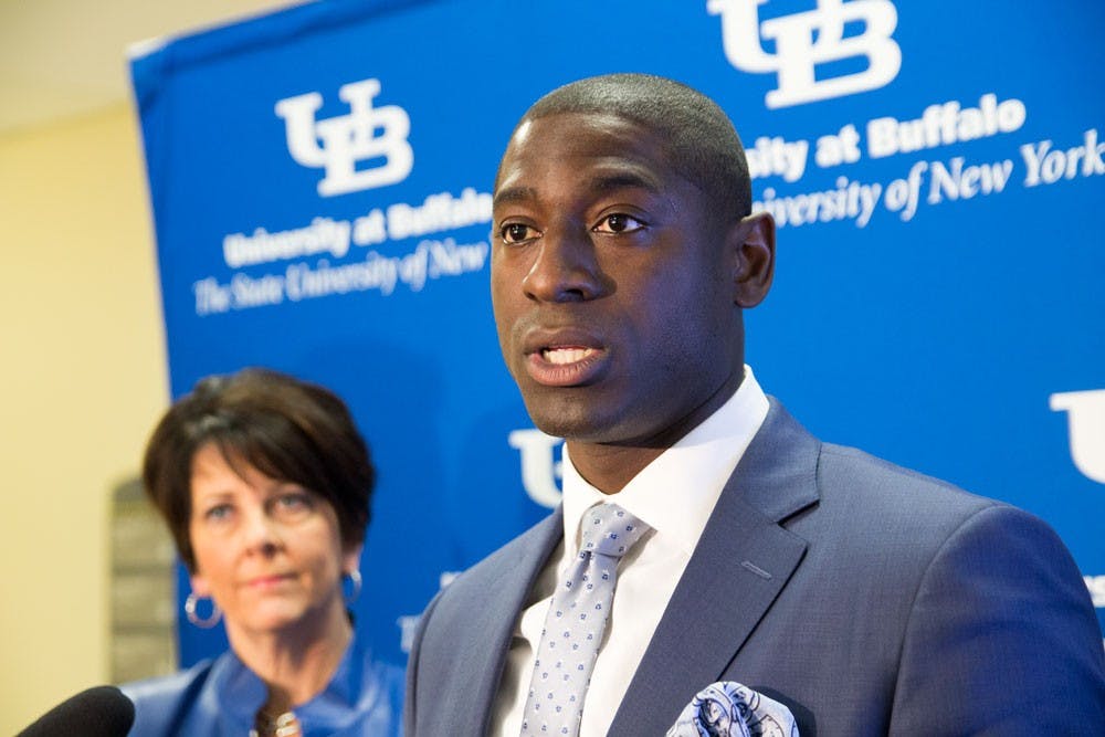 Athletic Director Allen Greene (front) speaks at Tuesday’s press conference in Capen Hall about UB Athletics’ new branding, as Nancy Paton (back), vice president of university communications, looks on. With a university-wide branding initiative, UB Athletics’ branding will no once again feature “Buffalo” prominently instead of “New York.”