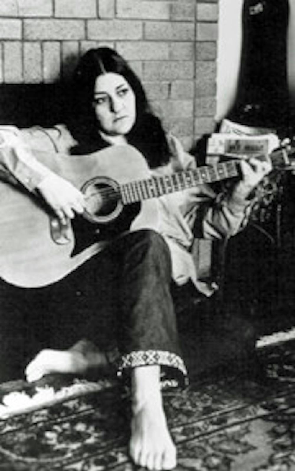 Madeline Davis playing the guitar
