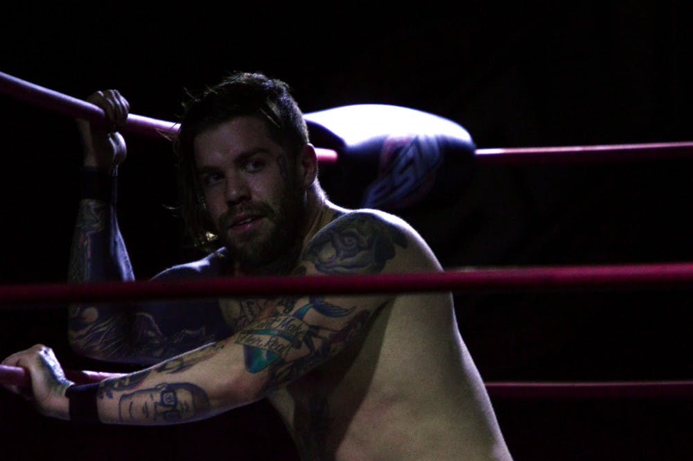 Kevin Lockwood pulls himself from the mat using the ring ropes. Lockwood is a naturally talented wrestler who wrestles for Smash Wrestling in Canada as Kevin Blackwood.