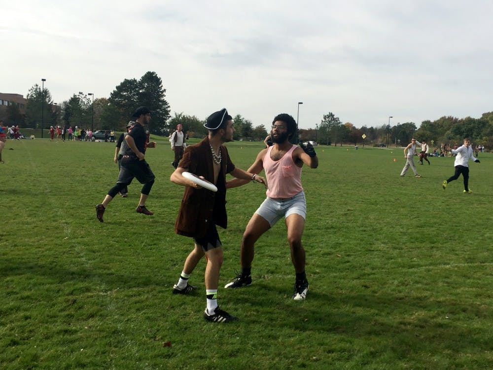 <p>A hustler tries blocking a pirate during an ultimate frisbee game. Many dream match-ups happened this past weekend at the Danse Macabre frisbee tournament.&nbsp;</p>