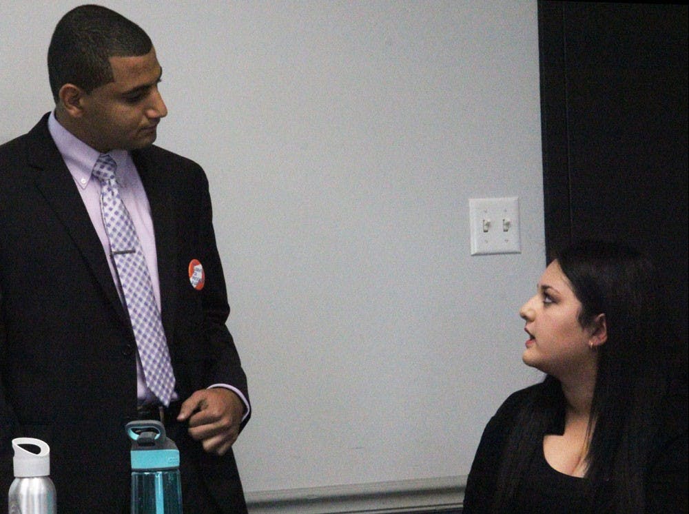 <p>Yaser Soliman (left) speaks to senator Alexis Ogra (right) during his senate chair election speech. Soliman lost the election, which SA's own attorney says was invalid, and is advocating for more university oversight of the Student Association. </p>
