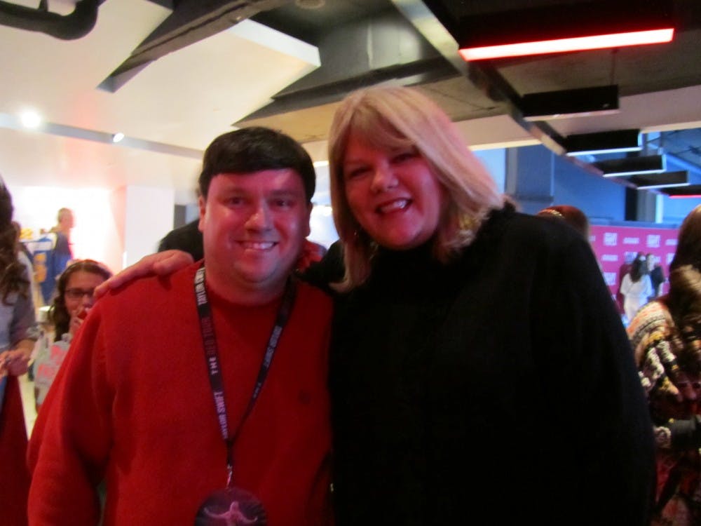 <p>Political science professor Shawn Donahue stands with Taylor Swift's mom during the St. Louis stop on the "Red Tour."</p>